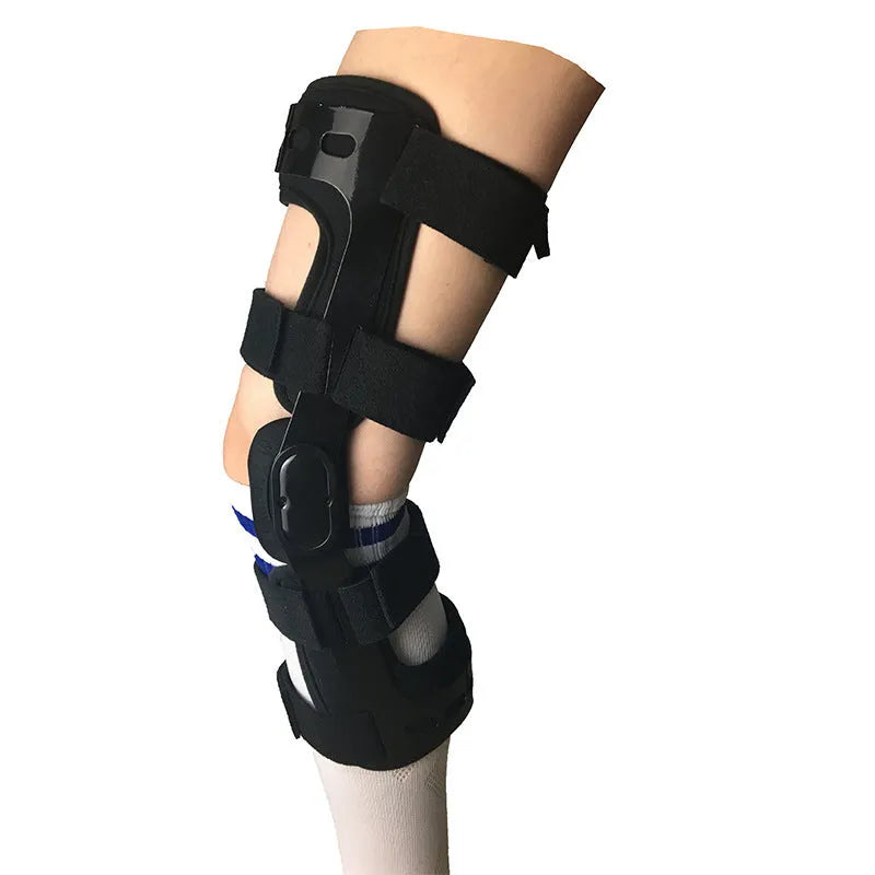 Black anterior ligament knee pad with metal stabiliser showing sandwich construction and sizing options