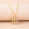 Gold crystal letter necklace with rhinestone initial on oval pendant and O-chain