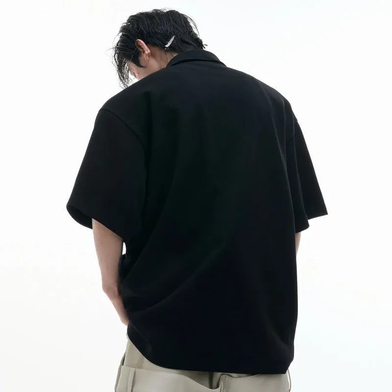 Men's deconstructed multi-collar polo shirt with geometric print in grey, showing loose fit and short sleeves.