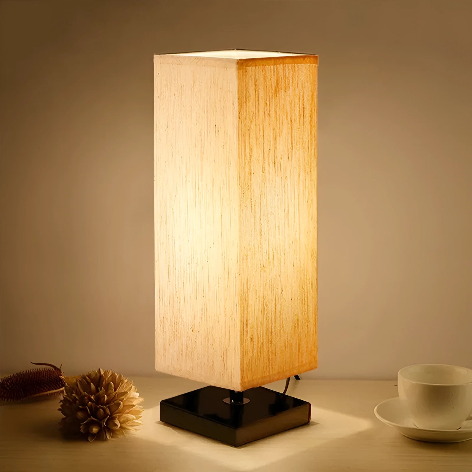 Modern simple square cloth covered table lamp 110V with E26 socket and off-white fabric shade on a desk
