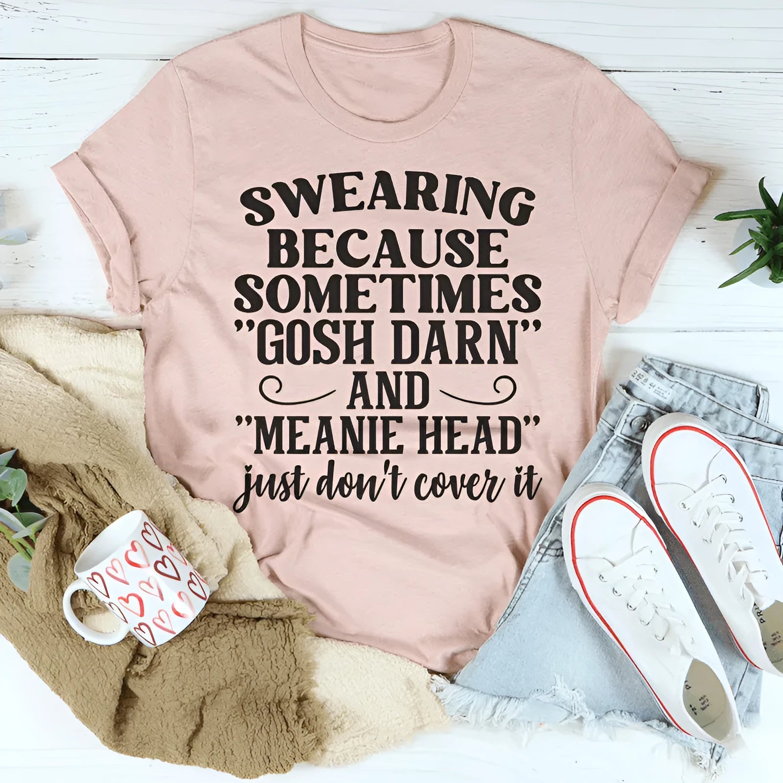A pink straight-cut couple's T-shirt with a printed design, showing short sleeves.