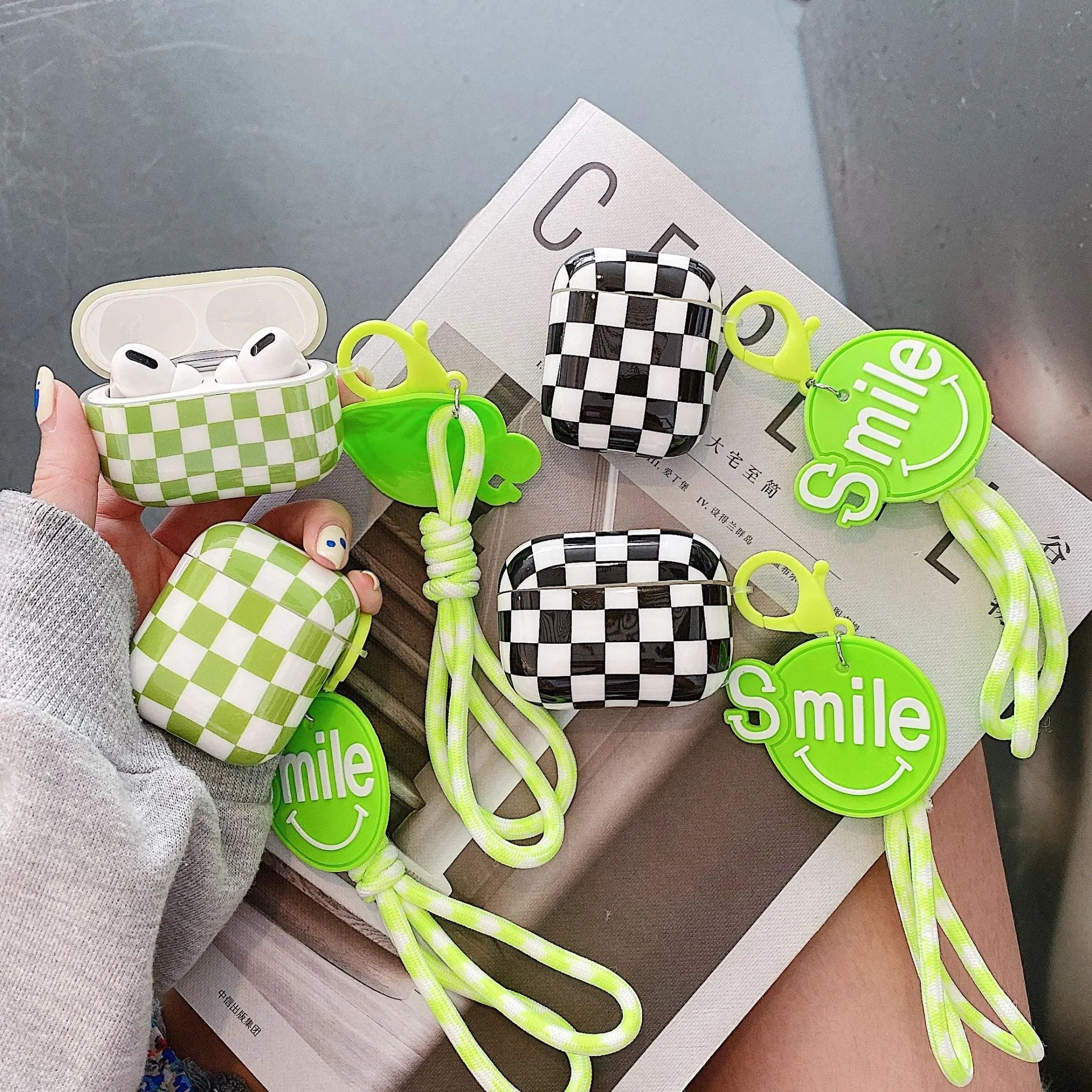 Black and green checkerboard pattern TPU protective cases for Apple AirPods with lanyard and loop pendant options.