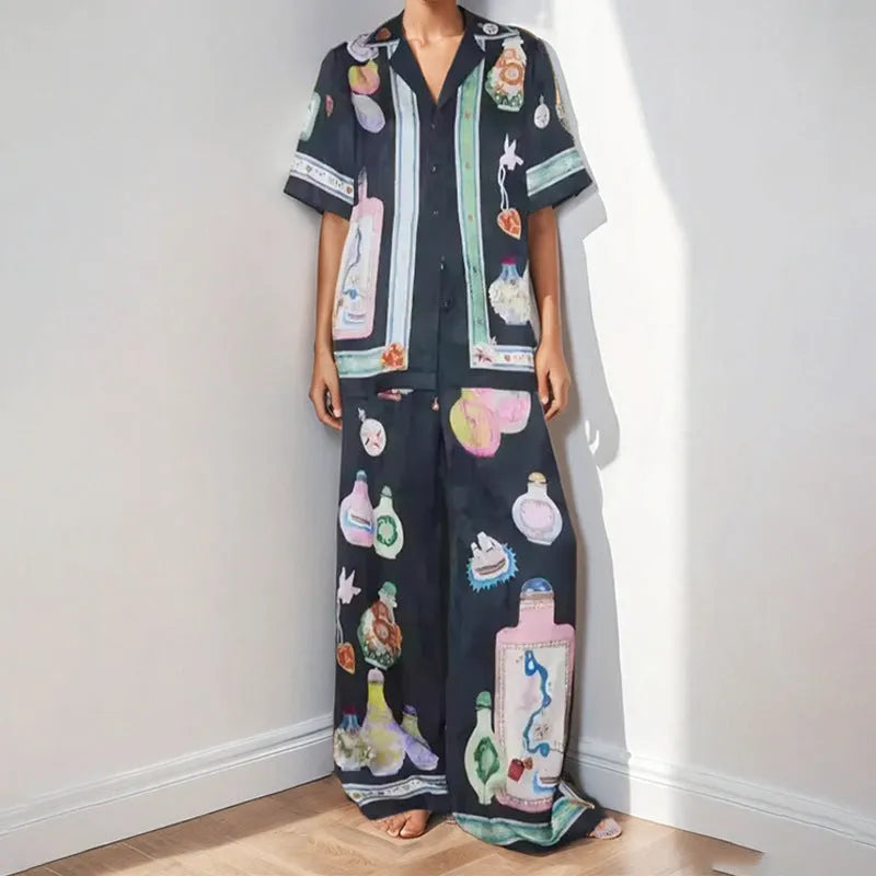 Black women's cardigan and trouser set with cartoon animation print.