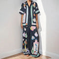 Black women's cardigan and trouser set with cartoon animation print.