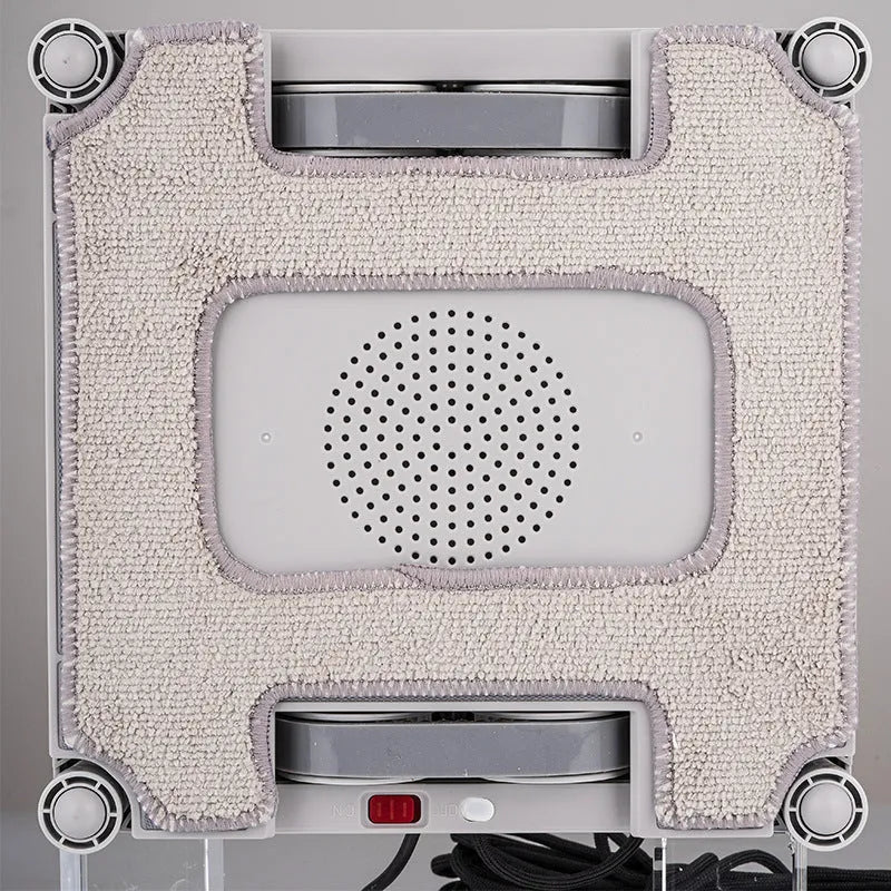 White intelligent window cleaning robot for high-rise buildings on a window pane.