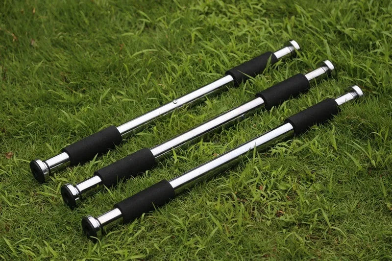 Steel adjustable pull-up bar extended in a home doorway for upper body workouts.
