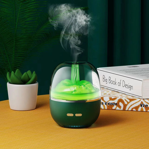 Green ultrasonic aromatherapy humidifier with heavy fog and colourful gradient light on a desk