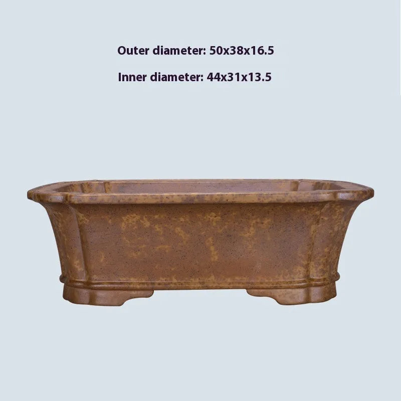 Large rectangular purple sand flowerpot with angled drainage base on a wooden patio.