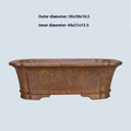 Large rectangular purple sand flowerpot with angled drainage base on a wooden patio.