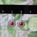 Handmade Miao silver and turquoise geometric flower disk earrings with totem patterns.