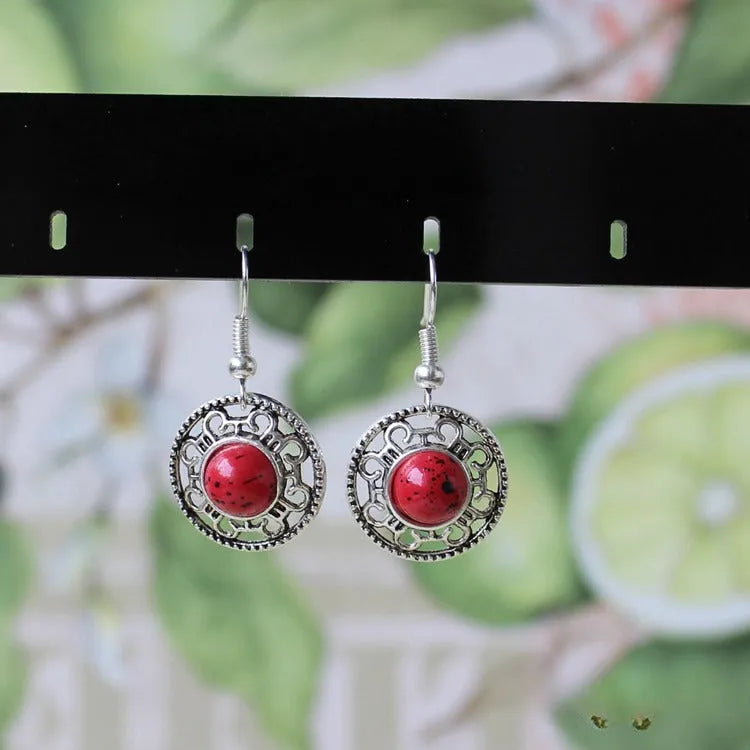 Handmade geometric Miao silver earrings with turquoise and auspicious cloud patterns in black, blue, or red.