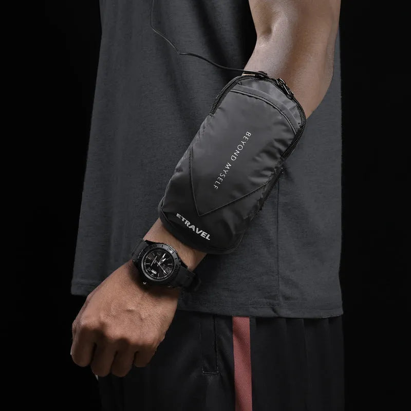 Black running arm bag with reflective strips, adjustable strap, and zip closure, shown on a person's arm.