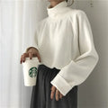 Women's apricot coloured half-high collar long sleeve loose fit top on a hanger