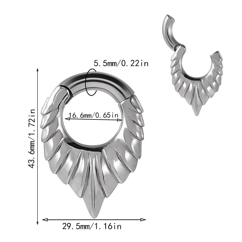 A single stainless steel teardrop-shaped ear extender for stretched lobes, showing a totem pattern on its face.