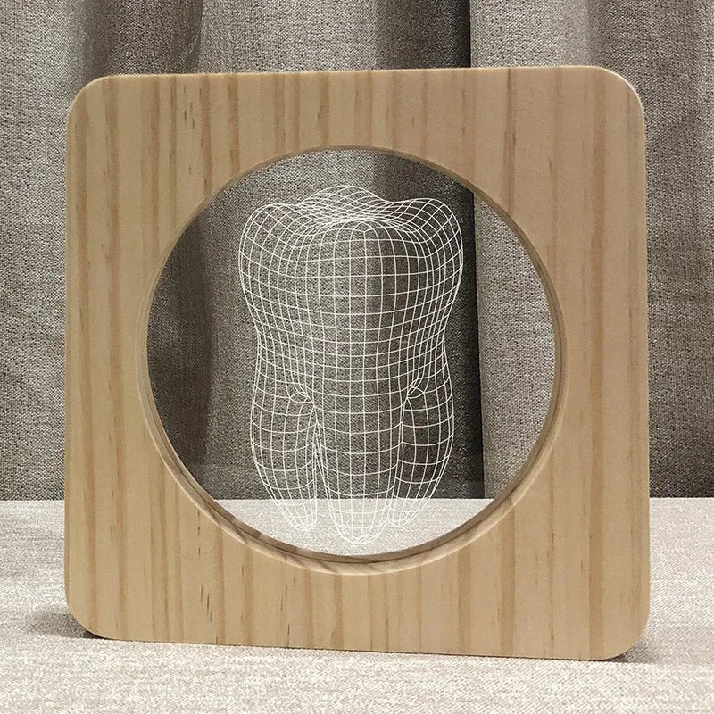 Wood colour tooth shaped acrylic night lamp with USB cable on wooden surface