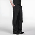 Black straight-leg trousers with adjustable waist and single pleat detail on a hanger.