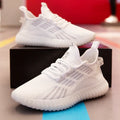 Men's white breathable flying fabric sports shoes with mesh lining and low upper design on a plain background.