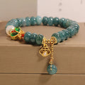 Blue water jade and white agate abacus bead bracelet with alloy inlay, rhinestones, and butterfly charm.