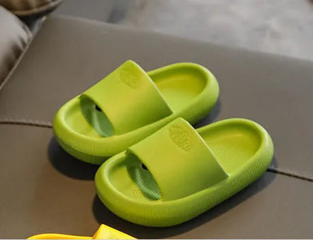 Children's mixed colour EVA slippers with textured sole, shown in blue, green, orange, pink, and yellow.