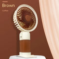 Handheld mini fan with phone holder, 16x8x6cm, five plastic blades, available in brown, pink, or blue.