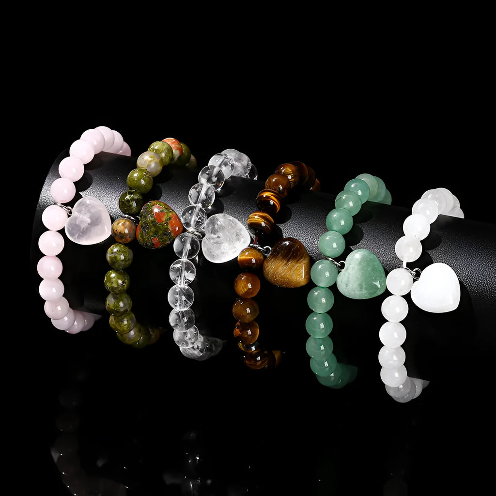 Natural crystal Tigereye love pendant bracelet with heart geometric design on woman's wrist.