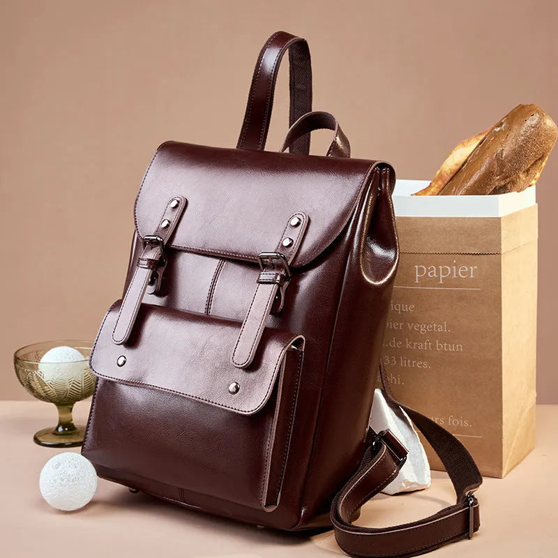 Black two-layer cowhide leather computer backpack for women with internal lining.