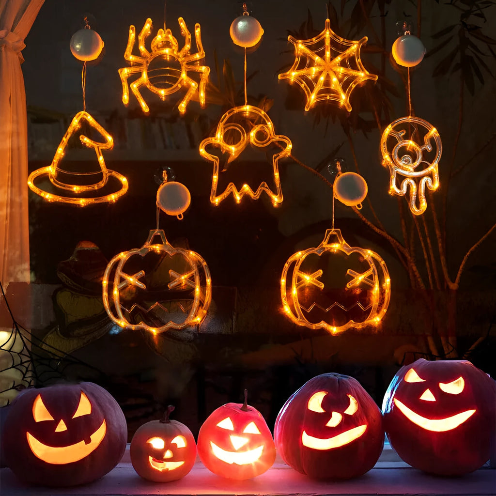 Halloween battery-powered LED window lights with spider, pumpkin and ghost figures hung by suction cups.