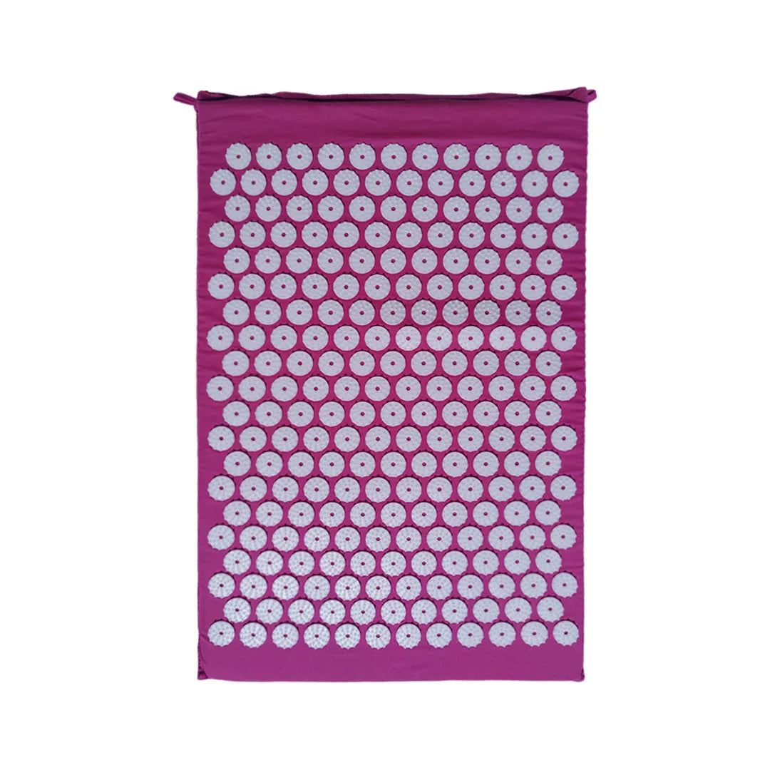 Black and blue acupuncture massage mat with cushion and headrest on floor