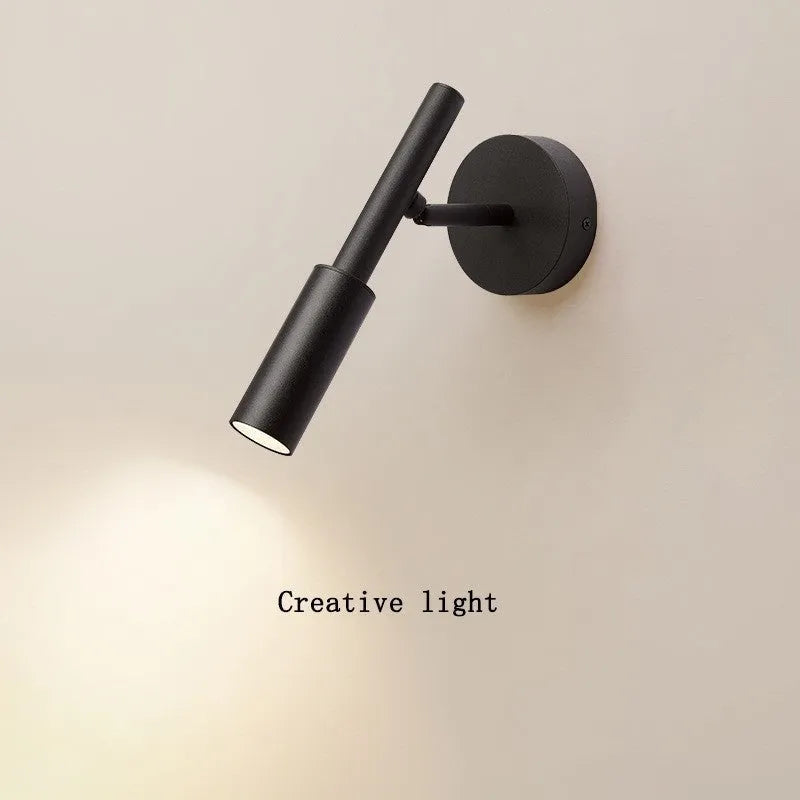 Black and white modern wrought iron wall lamp with a compact shade.