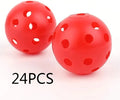 Assorted multi-colour golf practice balls in a net bag on a green surface.