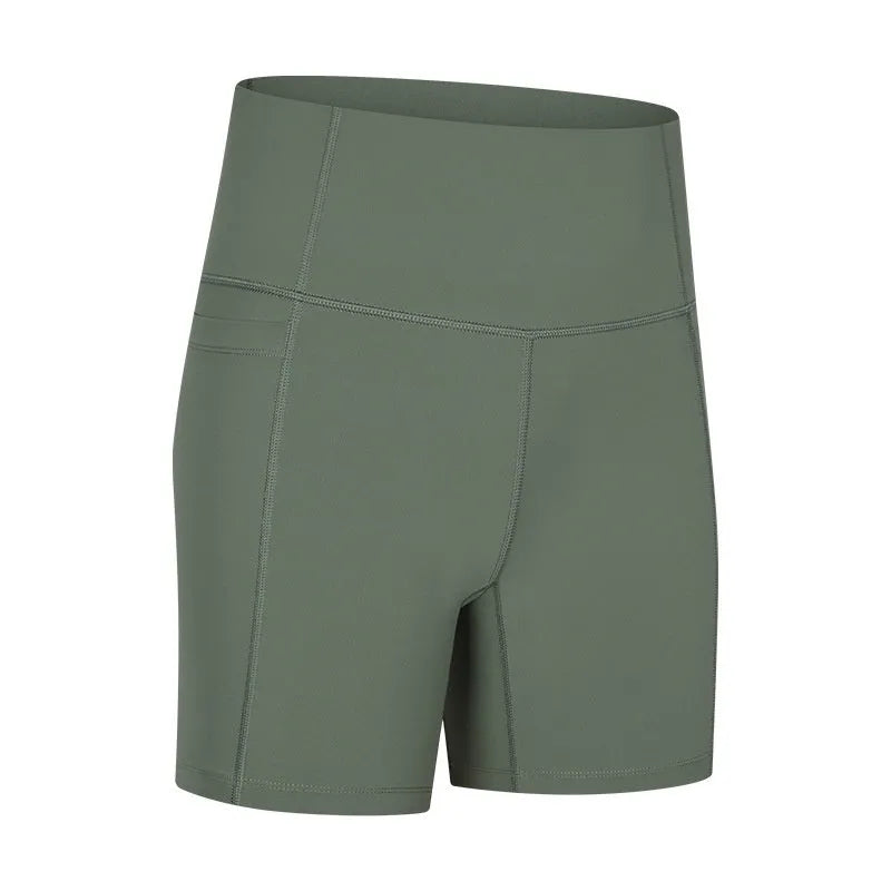 Women's solid colour mid-length sports shorts with a tight fit and waistband.