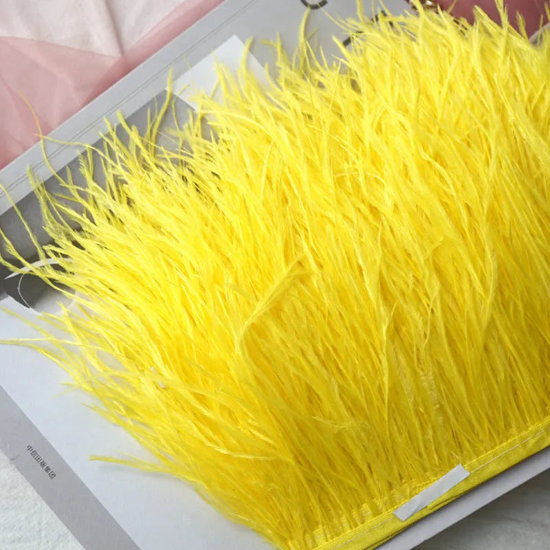 Decorative feather cloth strip in multiple colours including white, black, and mint green for DIY clothing and craft projects