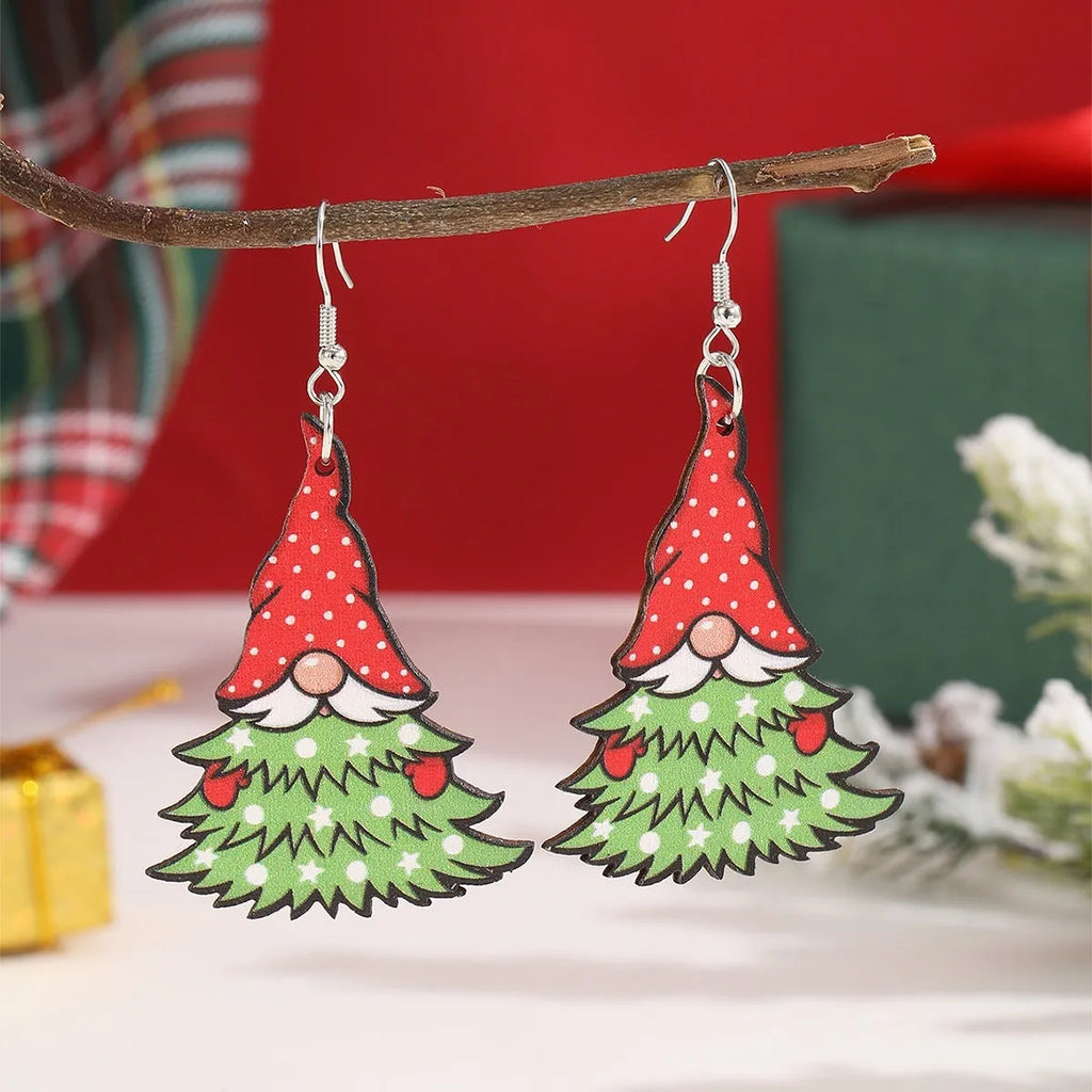 Wooden geometric Christmas earrings with printed festive designs on a white background.