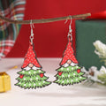 Wooden geometric Christmas earrings with printed festive designs on a white background.