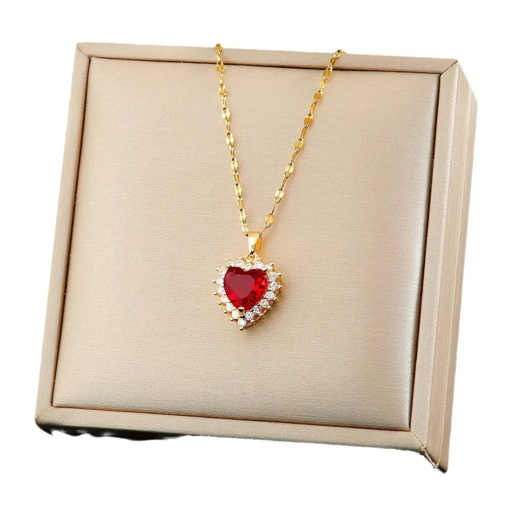 Gold-red titanium steel heart and flower necklace, earrings, and ring set on display