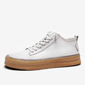 Men's black casual leather shoes with round toe and white rubber sole on a plain background.