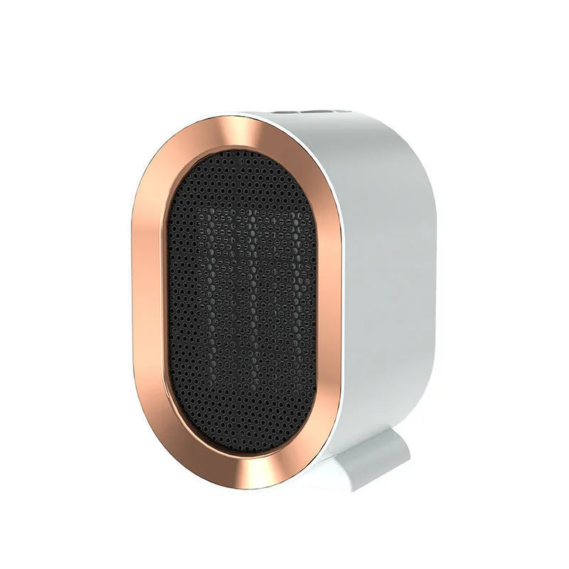 Compact desktop ceramic fan heater in black on a wooden desk.