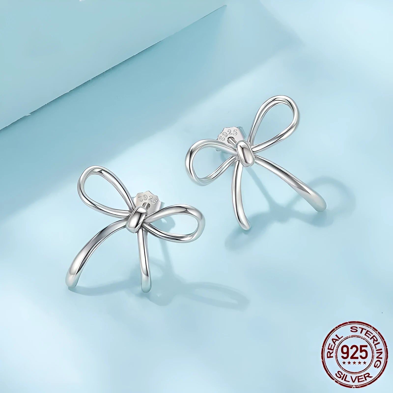 Simple S925 sterling silver stud earrings with polished finish on white background
