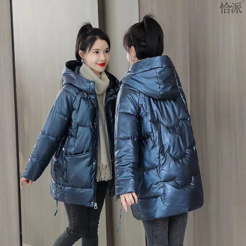 Women's loose-fitting long sleeve hooded jacket in black, shown on a hanger.