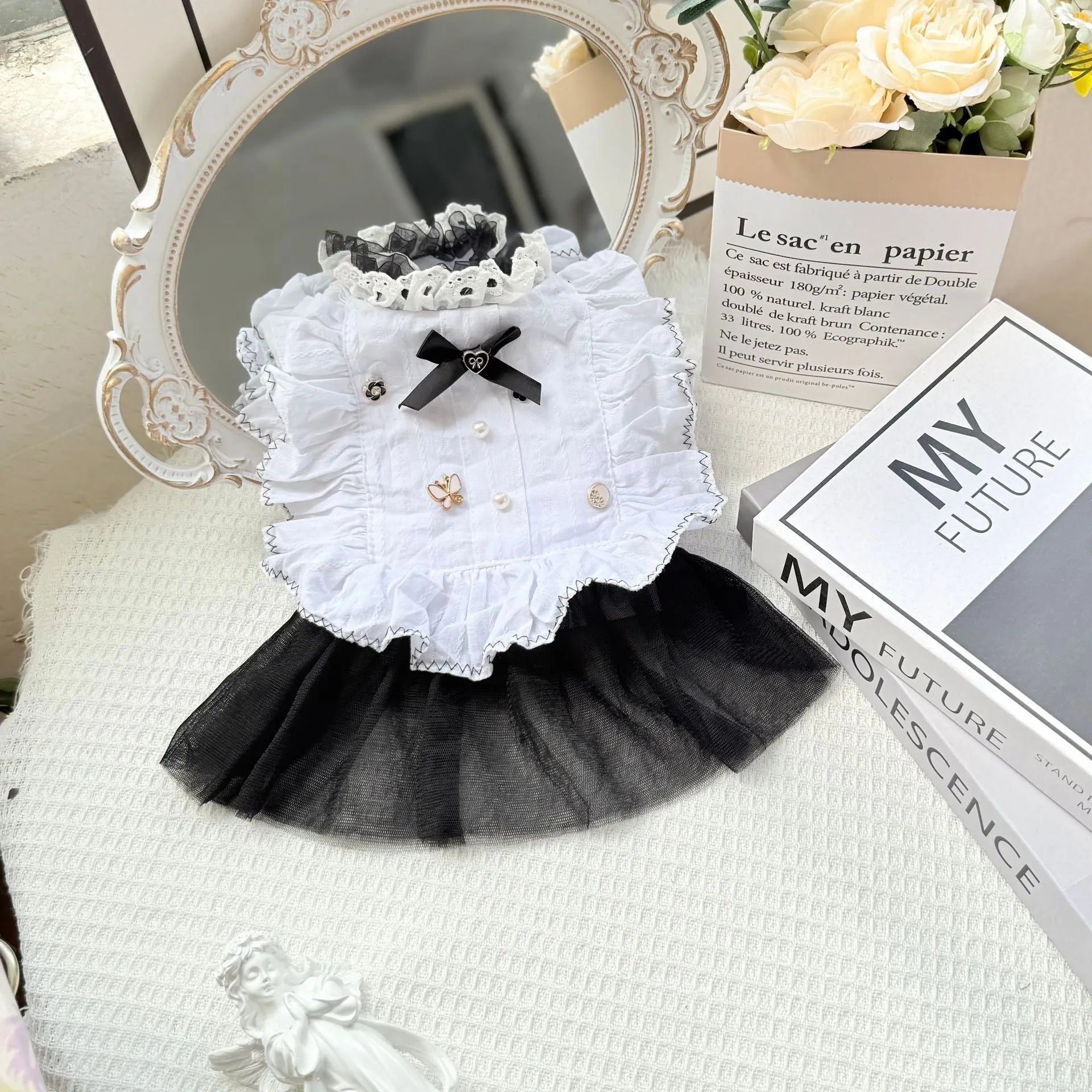 White yarn-trimmed polyester gauze skirt for a small dog on a mannequin, showing princess style.