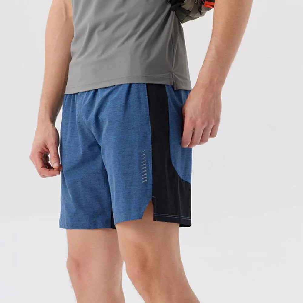 Man wearing forest green five-point single layer spandex casual shorts, showing mid-waist and shorts length fit.