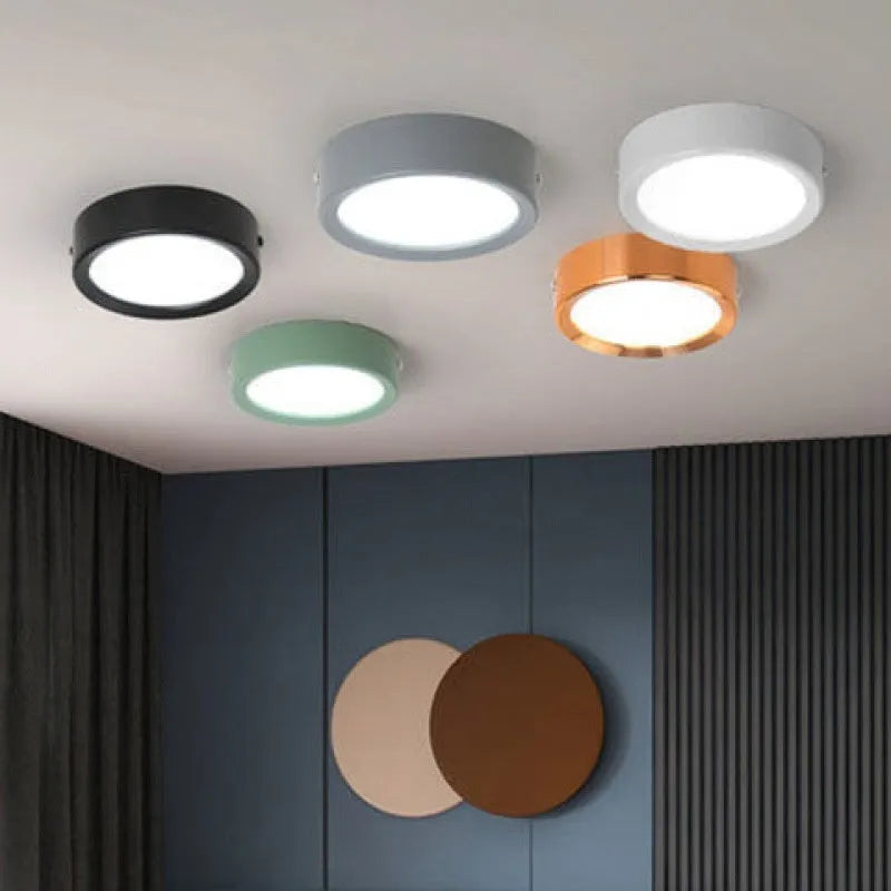 Ultra-thin surface mounted LED downlight in a choice of seven shell colours including black, white, gold, and pink.