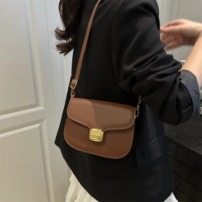 Simple PU leather women's handbag showing interior zipper coin compartment and phone pocket.