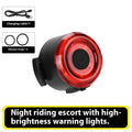 Round red bike warning light mounted on bicycle handlebar with silicone strap for night riding safety