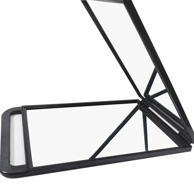 Double large folding hairdressing rearview mirror in black with HD double-sided reflective surface on a table