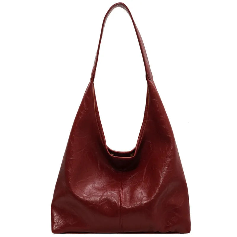 Soft black PU leather women's shoulder bag with large capacity and visible sewing thread detail.