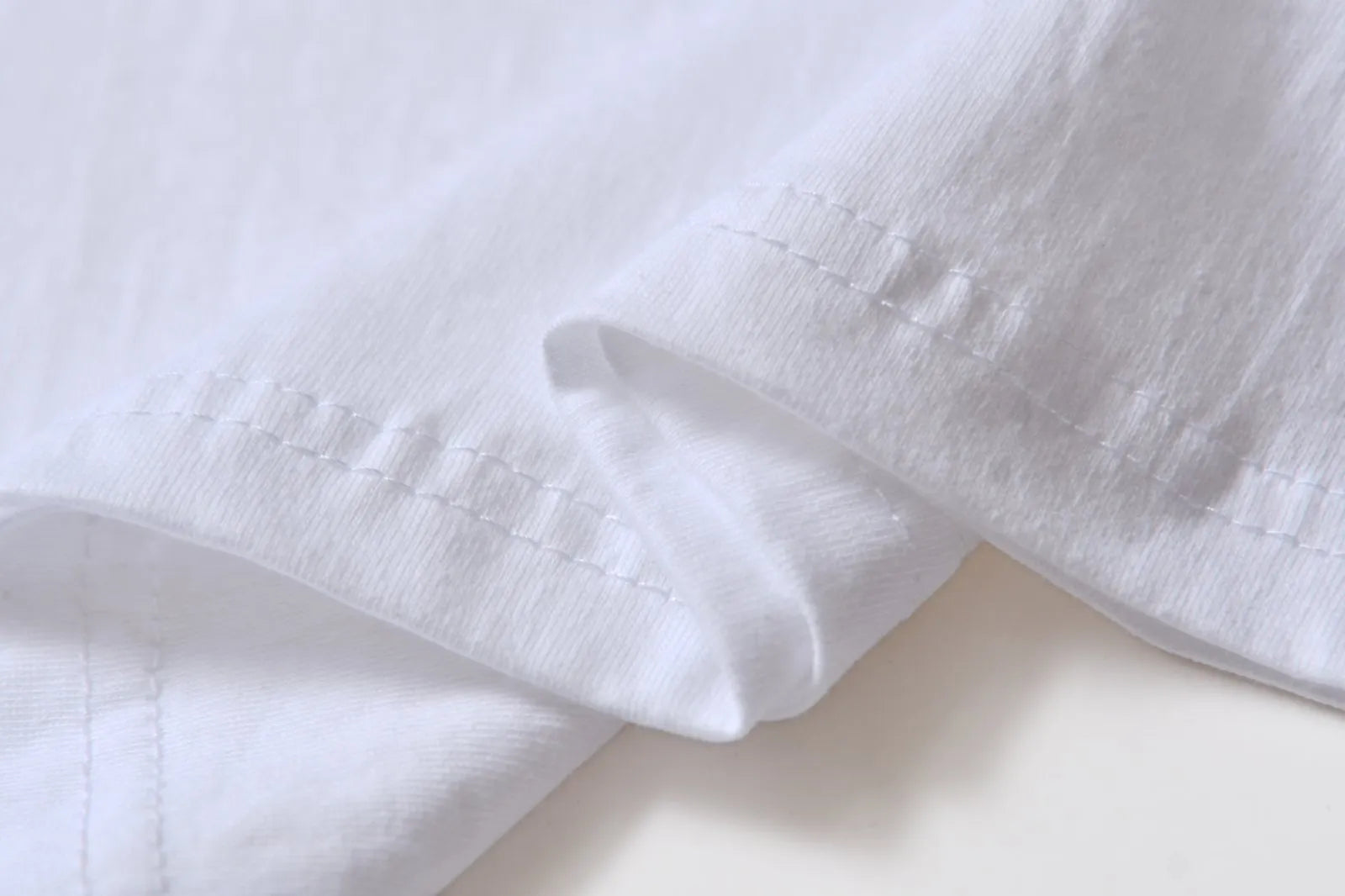 White cotton t-shirt overalls with short sleeves and a loose pullover fit