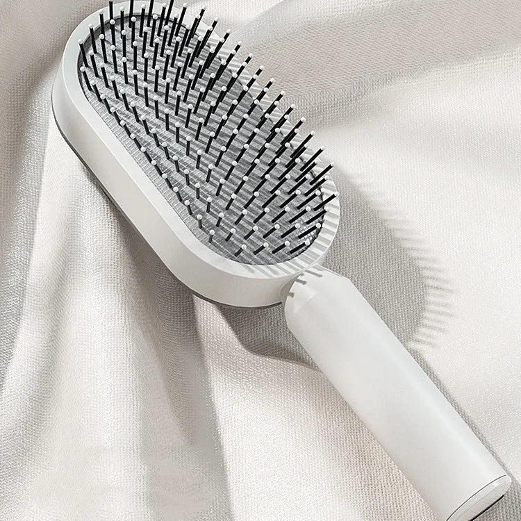 Self-cleaning hair brush with air cushion design in black gold, white, or black purple colours
