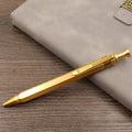 Brass tactical pen with six-ring press mechanism and cylindrical design in metallic finish