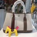 Women's canvas bucket tote bag with leather handles in black, available with crossbody strap and open top pocket